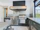 Luxury outdoor kitchen featuring stainless steel appliances and granite countertops at 15680 Panther Lake Dr, Winter Garden, FL 34787