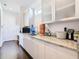 Modern butler's pantry with granite countertops and ample cabinetry at 15680 Panther Lake Dr, Winter Garden, FL 34787