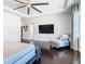 Main bedroom with hardwood floors, chaise lounge, and TV at 15680 Panther Lake Dr, Winter Garden, FL 34787