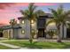 Stunning two-story home with a modern design and palm trees at 5708 Emerington Cres, Orlando, FL 32819