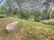 Peaceful backyard with lush greenery and a large stone at 232 Riverbend Dr # 201, Altamonte Springs, FL 32714