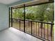 Screened balcony overlooking a tranquil wooded area at 232 Riverbend Dr # 201, Altamonte Springs, FL 32714