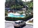 Community pool with gazebo and surrounding landscaping at 6682 Time Square Ave # 101, Orlando, FL 32835
