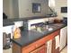 Modern kitchen features a double sink, ample counter space, and wood cabinets at 6682 Time Square Ave # 101, Orlando, FL 32835