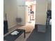 Living room with couches, coffee table, and kitchen view at 6682 Time Square Ave # 101, Orlando, FL 32835