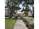 Community entrance with clock tower and landscaping at 6682 Time Square Ave # 101, Orlando, FL 32835