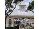 Gated community entrance with clock tower and signage at 6682 Time Square Ave # 101, Orlando, FL 32835