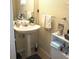 Small bathroom with pedestal sink and built-in shelving at 6682 Time Square Ave # 101, Orlando, FL 32835