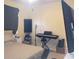 Bright bedroom with a bed, musical keyboard, and large TV at 6682 Time Square Ave # 101, Orlando, FL 32835