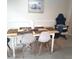 Dining area with table and chairs near a wall at 6682 Time Square Ave # 101, Orlando, FL 32835