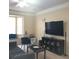 Living room with large TV and seating area at 6682 Time Square Ave # 101, Orlando, FL 32835