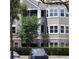 Building exterior with gray and beige siding, and screened balconies at 6682 Time Square Ave # 101, Orlando, FL 32835