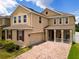 Two-story house with a brick driveway and red shutters at 1508 Caterpillar St, St Cloud, FL 34771