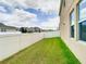 Grass backyard with a white fence and home at 1508 Caterpillar St, St Cloud, FL 34771