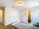 Bedroom with double doors and access to the hallway and bathroom at 1508 Caterpillar St, St Cloud, FL 34771