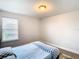 Bedroom with window, light flooring, and a bed with checkered bedding at 1508 Caterpillar St, St Cloud, FL 34771