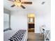 Bedroom with ceiling fan, window, and adjacent bathroom at 1508 Caterpillar St, St Cloud, FL 34771