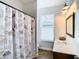 Bathroom with a Paris-themed shower curtain and modern vanity at 1508 Caterpillar St, St Cloud, FL 34771
