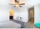 Bedroom with ceiling fan, desk, and access to bathroom at 1508 Caterpillar St, St Cloud, FL 34771