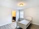 Bedroom with a bed, window, and access to a bathroom at 1508 Caterpillar St, St Cloud, FL 34771