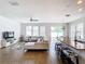 Spacious living room featuring a large sectional sofa and ample natural light at 1508 Caterpillar St, St Cloud, FL 34771