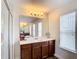 Bathroom with a double vanity and large mirror at 1508 Caterpillar St, St Cloud, FL 34771