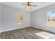 Bright bedroom with wood-look tile flooring and large windows at 2017 W State Road 426, Oviedo, FL 32765