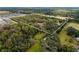 Aerial view of a large lot, bordered by trees and neighboring properties at 2017 W State Road 426, Oviedo, FL 32765