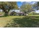 Single story home with large yard and mature trees at 2017 W State Road 426, Oviedo, FL 32765