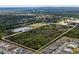 Aerial view of a large lot with surrounding houses and a lake at 2017 W State Road 426, Oviedo, FL 32765