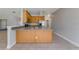 Kitchen features wood cabinets, stainless steel appliances, and a breakfast bar at 2017 W State Road 426, Oviedo, FL 32765