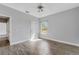 Spacious bedroom with wood-look tile floors and large window at 2017 W State Road 426, Oviedo, FL 32765