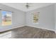 Bright bedroom with wood-look tile flooring and ceiling fan at 2017 W State Road 426, Oviedo, FL 32765