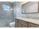 Updated bathroom with gray cabinets and a large shower at 2017 W State Road 426, Oviedo, FL 32765