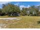 View of two smaller structures on a property with grassy areas at 2017 W State Road 426, Oviedo, FL 32765