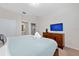 King-size bed, TV, and dresser in this well-lit room at 2588 Shanti Dr, Kissimmee, FL 34746