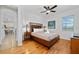 Bright bedroom with wood floors and king-size bed at 2588 Shanti Dr, Kissimmee, FL 34746