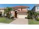 Two-story house with double garage and landscaped yard at 2588 Shanti Dr, Kissimmee, FL 34746