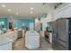 Modern kitchen with center island, white cabinets, and mosaic backsplash at 1112 N Peninsula Ave, New Smyrna Beach, FL 32169