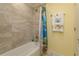 Bathroom with bathtub and colorful shower curtain at 1112 N Peninsula Ave, New Smyrna Beach, FL 32169