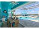 Inviting pool area with patio furniture, a covered patio, and a view of the water at 1112 N Peninsula Ave, New Smyrna Beach, FL 32169