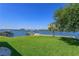 Expansive waterfront view with lush lawn and boat dock at 1112 N Peninsula Ave, New Smyrna Beach, FL 32169