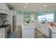 Spacious kitchen featuring white cabinets, granite counters, and stainless steel appliances at 1112 N Peninsula Ave, New Smyrna Beach, FL 32169
