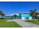 Beautiful teal home with a large driveway and two-car garage at 1112 N Peninsula Ave, New Smyrna Beach, FL 32169