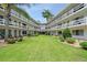 Courtyard view of Maitland Harbour, showing lush green lawn and building at 1000 S Orlando Ave # A5, Maitland, FL 32751