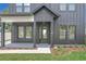 Modern front entrance with black door and white trim, surrounded by landscaping at 3480 Fairway Ln, Orlando, FL 32804