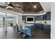 Modern basement bar with blue cabinetry, marble countertops, and lake views at 9832 Laurel Valley Dr, Windermere, FL 34786
