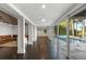 Long hallway connecting basement rooms with herringbone floors and pool access at 9832 Laurel Valley Dr, Windermere, FL 34786