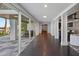 Bright hallway leading to the pool, with herringbone floors and large windows at 9832 Laurel Valley Dr, Windermere, FL 34786