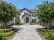 Grand entrance of a stunning home with a brick paved driveway at 9832 Laurel Valley Dr, Windermere, FL 34786